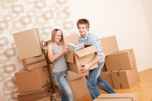 Unloading boxes into a new Pimlico apartment with organized placement